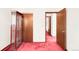 An open bedroom showcasing a built-in shelf, closet space, and an open door leading to an adjacent room at 4034 S Atchison Way, Aurora, CO 80014