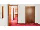 Bedroom featuring an open doorway to a connecting room, neutral walls, and closet space at 4034 S Atchison Way, Aurora, CO 80014