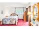 Bedroom features a double bed with patterned comforter and two side tables with lamps and decorations at 4034 S Atchison Way, Aurora, CO 80014