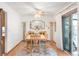 Light-filled dining room featuring hardwood floors, a ceiling fan, and sliding glass doors to the outside at 4034 S Atchison Way, Aurora, CO 80014