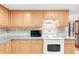 A view of the kitchen showcasing the cabinets, countertops, tile backsplash, and stainless appliances at 4034 S Atchison Way, Aurora, CO 80014