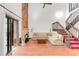 Open living room featuring hardwood floors, fireplace, and staircase at 4034 S Atchison Way, Aurora, CO 80014