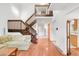 Spacious living room with hardwood floors, a staircase, and a view of the upstairs balcony at 4034 S Atchison Way, Aurora, CO 80014