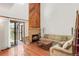 Bright living room with hardwood floors, a corner fireplace, and an open staircase at 4034 S Atchison Way, Aurora, CO 80014