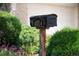 Curbside mailbox with house numbers surrounded by lush landscaping and vibrant flowers at 4034 S Atchison Way, Aurora, CO 80014