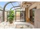 Bright sunroom with glass ceiling, ceiling fan, and sliding glass doors leading to an outdoor deck at 4034 S Atchison Way, Aurora, CO 80014