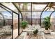 Sunroom featuring glass panes, indoor plants, and cushioned seating at 4034 S Atchison Way, Aurora, CO 80014