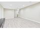Spacious basement features neutral walls, recessed lighting and light gray woodgrain floors at 9236 E 52Nd Dr, Denver, CO 80238