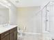 Full bathroom with a glass-enclosed shower, dark wood vanity, a neutral wall color, and tile flooring at 9236 E 52Nd Dr, Denver, CO 80238