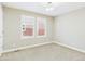 Bright bedroom featuring neutral walls, carpet, modern lighting, and bright windows at 9236 E 52Nd Dr, Denver, CO 80238