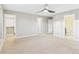 Bright bedroom with neutral walls, carpet flooring, ceiling fan, and doorways to other rooms at 9236 E 52Nd Dr, Denver, CO 80238