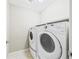 Laundry room featuring a modern washer and dryer, and tile flooring at 9236 E 52Nd Dr, Denver, CO 80238