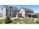Expansive backyard featuring a patio, lush lawn, mature landscaping, and a covered porch area at 970 Inyokern Ct, Watkins, CO 80137