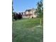 Spacious front yard with manicured lawn leading up to a charming two-story home with a welcoming front porch at 970 Inyokern Ct, Watkins, CO 80137