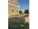 Beautifully landscaped garden bed featuring colorful flowers, decorative stone edging, and a tiered retaining wall at 970 Inyokern Ct, Watkins, CO 80137