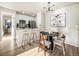 Dining area with a round table, chairs and modern light fixture at 7870 W 87Th Dr # L, Arvada, CO 80005