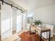 Light-filled home office with built-in shelving and a barn door at 7870 W 87Th Dr # L, Arvada, CO 80005