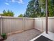 Private patio with gravel ground cover and wooden fence at 7870 W 87Th Dr # L, Arvada, CO 80005