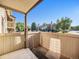 Small, fenced patio with gravel and gardening tool at 7870 W 87Th Dr # L, Arvada, CO 80005