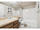 Bright bathroom featuring tiled backsplash, a sink, and toilet at 3333 E Florida Ave # 108, Denver, CO 80210