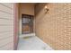 Charming front porch with brick wall and security screen door at 3333 E Florida Ave # 108, Denver, CO 80210