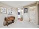 Hallway with art leading to a laundry room and bathroom at 3333 E Florida Ave # 108, Denver, CO 80210