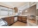 Kitchen featuring classic wood cabinetry and view of the breakfast nook area at 3333 E Florida Ave # 108, Denver, CO 80210