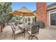Backyard patio featuring umbrella-covered table set, barbecue grill, and hot tub for outdoor enjoyment at 19770 E Geddes Pl, Centennial, CO 80016