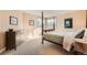 Comfortable bedroom featuring a four poster bed, neutral tones, carpet, and many windows at 19770 E Geddes Pl, Centennial, CO 80016