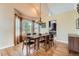 Dining room with vaulted ceiling, large windows, chandelier, and hardwood floors at 19770 E Geddes Pl, Centennial, CO 80016