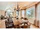 Bright dining room featuring hardwood floors, large windows, and elegant chandelier at 19770 E Geddes Pl, Centennial, CO 80016