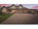 Beautiful brick home with a spacious driveway and multiple garage doors at 19770 E Geddes Pl, Centennial, CO 80016
