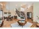 Open-concept space with hardwood floors, staircase, and elegant dining area at 19770 E Geddes Pl, Centennial, CO 80016