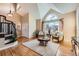 Bright living room featuring hardwood floors, vaulted ceiling, and large arched window at 19770 E Geddes Pl, Centennial, CO 80016