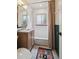 Bright bathroom featuring a classic tub-shower combination with subway tile and a modern vanity at 2965 S Gilpin St, Denver, CO 80210