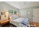Comfortable bedroom featuring a bed with nightstands, natural light, and closet storage space at 2965 S Gilpin St, Denver, CO 80210