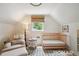 Bright bedroom featuring a crib, comfortable chair, and a peaceful ambiance at 2965 S Gilpin St, Denver, CO 80210