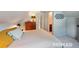 Cozy bedroom with a comfortable bed, dresser, and views into the ensuite bathroom at 2965 S Gilpin St, Denver, CO 80210