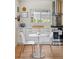Bright kitchen with white cabinets, stainless steel appliances, and a cozy dining area at 2965 S Gilpin St, Denver, CO 80210