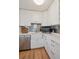 Well-designed kitchen with stainless steel appliances, white cabinets, and ample counter space at 2965 S Gilpin St, Denver, CO 80210