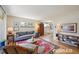 Bright living room featuring hardwood floors, a large window, and stylish furnishings at 2965 S Gilpin St, Denver, CO 80210