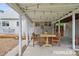 Inviting covered patio with string lights, dining area for outdoor relaxation and entertainment at 2965 S Gilpin St, Denver, CO 80210