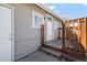 Porch includes a weathered-looking deck and stairs to the backyard at 6521 E 70Th Pl, Commerce City, CO 80022