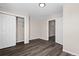 Bedroom featuring modern wood flooring, closet, and neutral paint tones throughout the space at 6521 E 70Th Pl, Commerce City, CO 80022