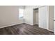 Bedroom featuring modern wood flooring, window, and neutral paint tones throughout the space at 6521 E 70Th Pl, Commerce City, CO 80022