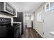 Bright eat-in kitchen features black appliances, lots of cabinets and luxury vinyl plank flooring at 6521 E 70Th Pl, Commerce City, CO 80022