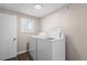 Laundry room featuring modern wood flooring and a window at 6521 E 70Th Pl, Commerce City, CO 80022