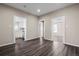 Inviting living room featuring modern wood flooring and neutral paint tones throughout the space at 6521 E 70Th Pl, Commerce City, CO 80022