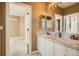 Spacious bathroom with double sinks, mirrors and lighting, and a view into additional room at 10040 Longview Dr, Lone Tree, CO 80124