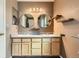 Well-lit bathroom featuring double sinks, granite countertops, and stylish round mirrors for a modern touch at 9651 Bighorn Way, Littleton, CO 80125